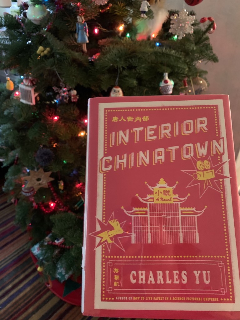 Charles Yu's novel "Interior Chinatown" in front of Christmas tree